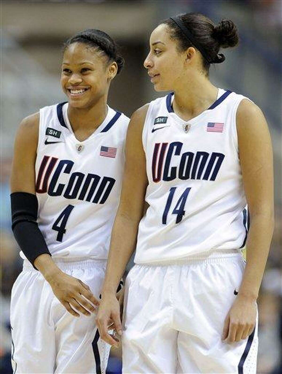 Connecticut's Moriah Jefferson, left, and Bria Hartley smile late in the second half of their team's 94-37 victory over Marquette in an NCAA college basketball game in Storrs, Conn., Tuesday, Feb. 5, 2013. (AP Photo/Fred Beckham)