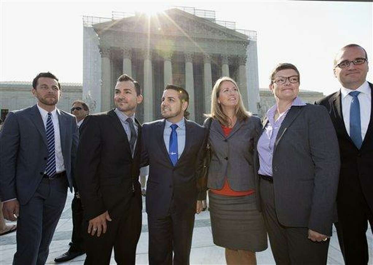 Arriving at the Supreme Court in Washington, Wednesday, June 26, 2013, on a final day for decisions in two gay marriage cases are plaintiffs in the California Proposition 8 case. From left are, Adam Umhoefer, executive director of the American Foundation for Equal Rights, plaintiffs Paul Katami, his partner Jeff Zarrillo, Sandy Stier and her partner Kris Perry, and Chad Griffin, president of the Human Rights Campaign. (AP Photo/J. Scott Applewhite)