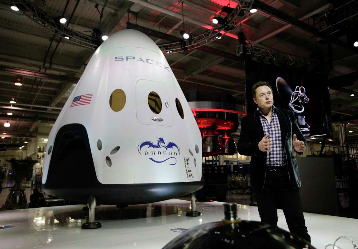 In this May 29, 2014 photo, Elon Musk, CEO and CTO of SpaceX, introduces the SpaceX Dragon V2 spaceship at the SpaceX headquarters in Hawthorne, Calif. On Tuesday, Sept. 16, 2014, (AP Photo/Jae C. Hong, file)