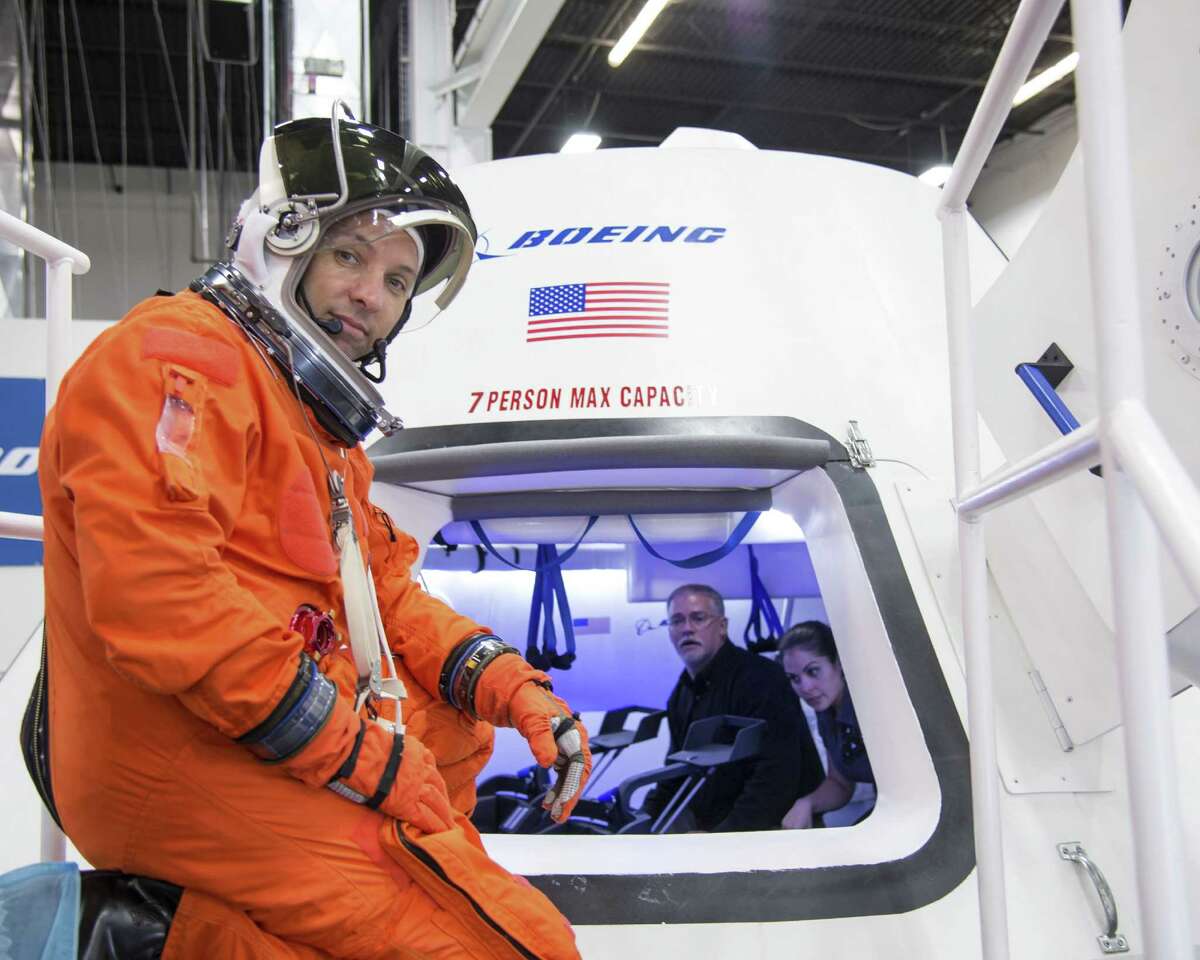 In this undated image provided by NASA, astronaut Randy Bresnik prepares to enter The Boeing Company’s CST-100 spacecraft for a fit check evaluation at the company’s Houston Product Support Center. (AP Photo/NASA)