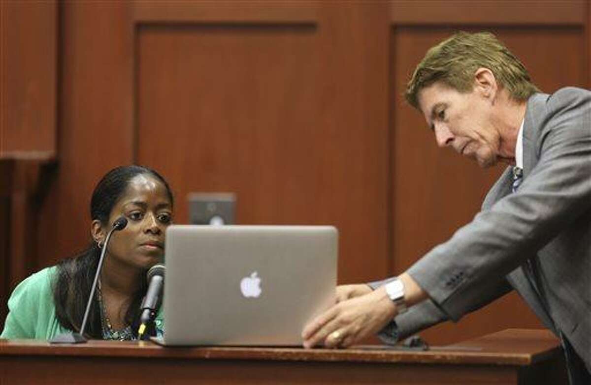 Defense attorney Mark O'Mara has state witness Selene Bahadoor read from her Facebook page while testifying during George Zimmerman's trial in Seminole circuit court in Sanford, Fla. Tuesday, June 25, 2013. Zimmerman has been charged with second-degree murder for the 2012 shooting death of Trayvon Martin. (AP Photo/Orlando Sentinel, Gary W. Green, Pool)