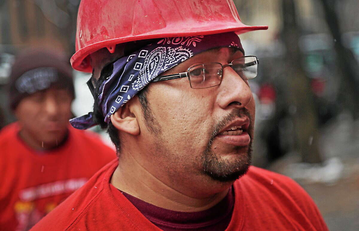 Day laborer Martin Garcia, a day laborer from Mexico, takes a break from a carpentry job.
