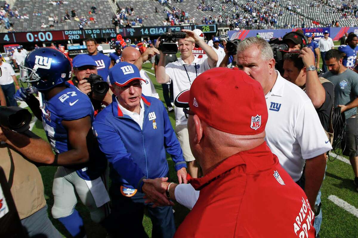 Giants head coach Tom Coughlin shakes hands with Cardinals head coach Bruce Arians after Sunday’s game.