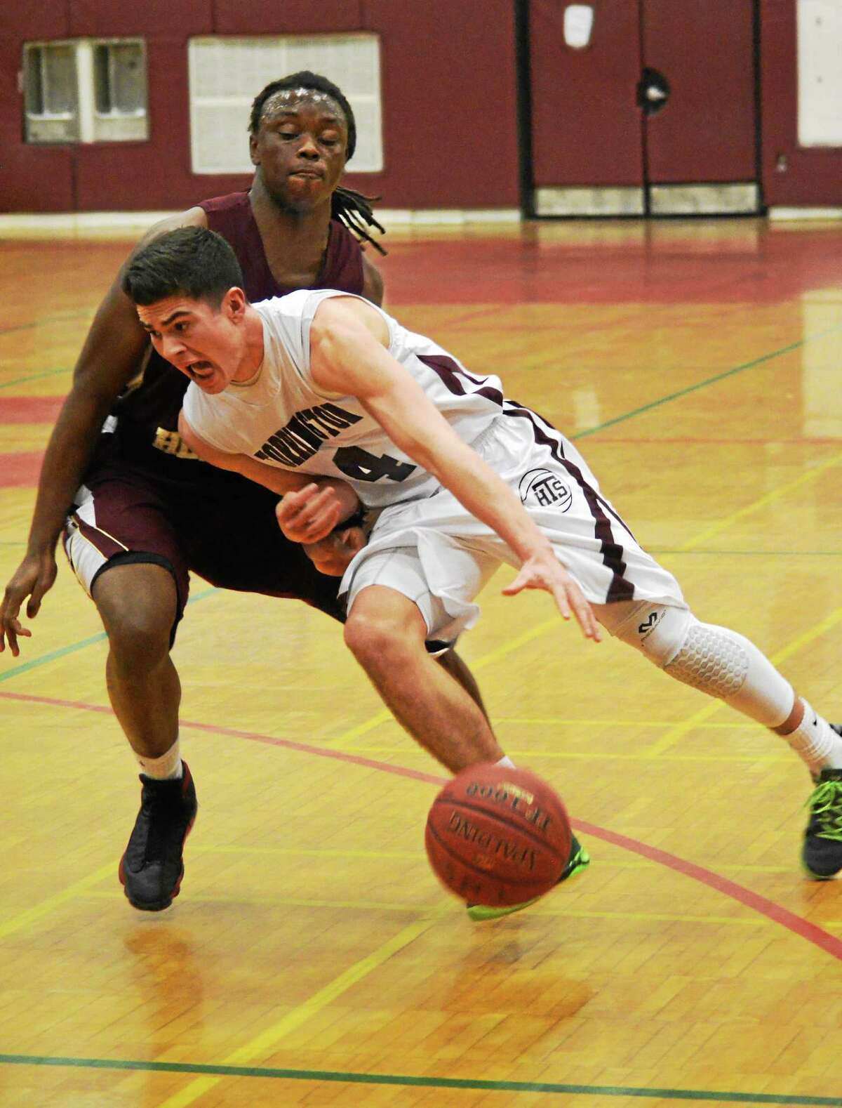 Torrington’s John McCarthy drives to the lane in the Red Raiders’ 77-56 loss to Sacred Heart.