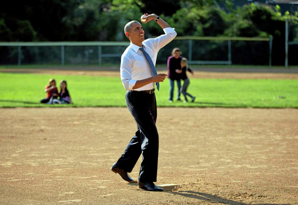 President Barack Obama throws a pitch to members of the Northwest little league baseball teams at Friendship Park in Washington on Monday.