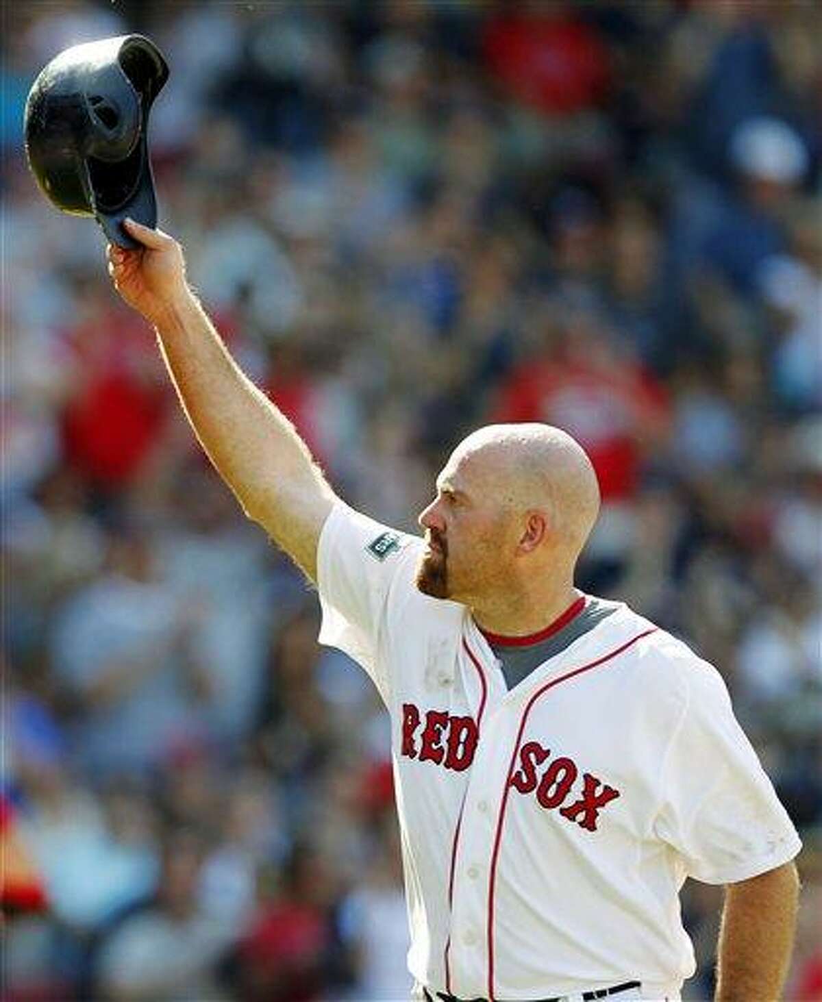 FILE - In this June 24, 2012, file photo, Boston Red Sox's Kevin Youkilis tips his helmet as he comes off the field after hitting a triple and being replaced with a pinch runner in the seventh inning of a baseball game against the Atlanta Braves in Boston. A person familiar with the negotiations told The Associated Press Tuesday, Dec. 11, that free agent Youkilis and the New York Yankees have reached agreement on a $12 million, one-year deal. (AP Photo/Michael Dwyer, File)