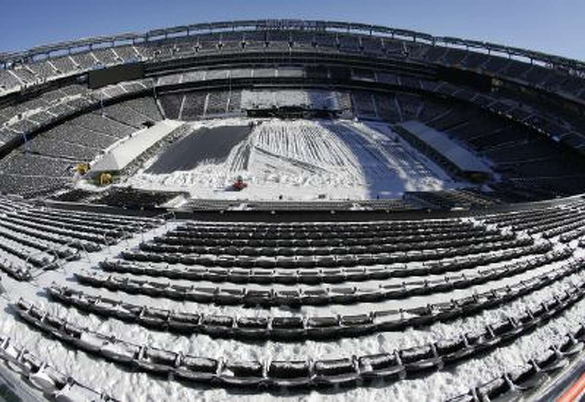 Snow is accumulated on the seats and on the field of MetLife Stadium Wednesday, in East Rutherford, N.J.