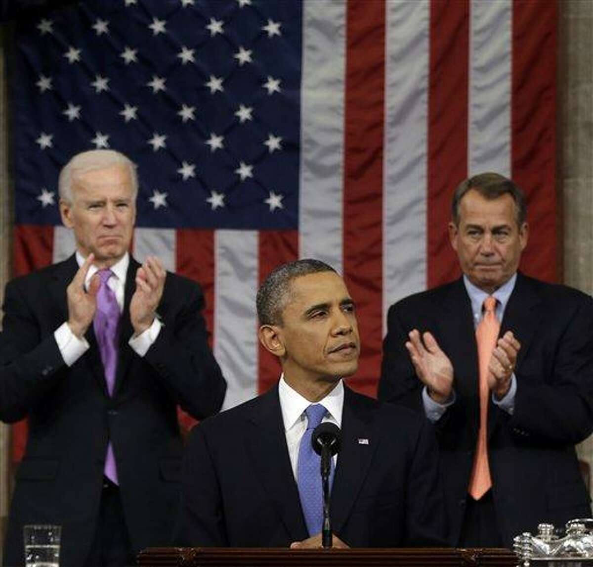Vice President Joe Biden and House Speaker John Boehner of Ohio applaud President Barack Obama as he gives his State of the Union address during a joint session of Congress on Capitol Hill in Washington, Tuesday Feb. 12, 2013. (AP Photo/Charles Dharapak, Pool)
