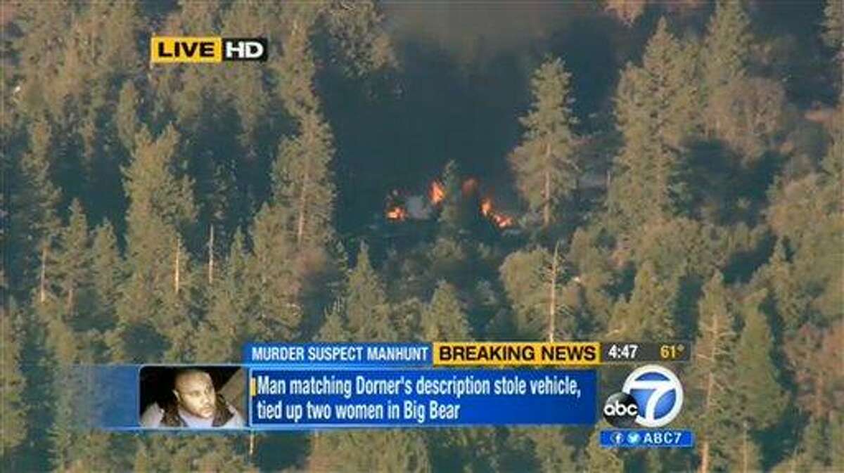 In this image taken from video provided by KABC-TV, the cabin in Big Bear, Calif. where ex-Los Angeles police officer Christopher Dorner is believed to be barricaded inside is in flames Tuesday, Feb. 12, 2013. (AP Photo/KABC-TV)