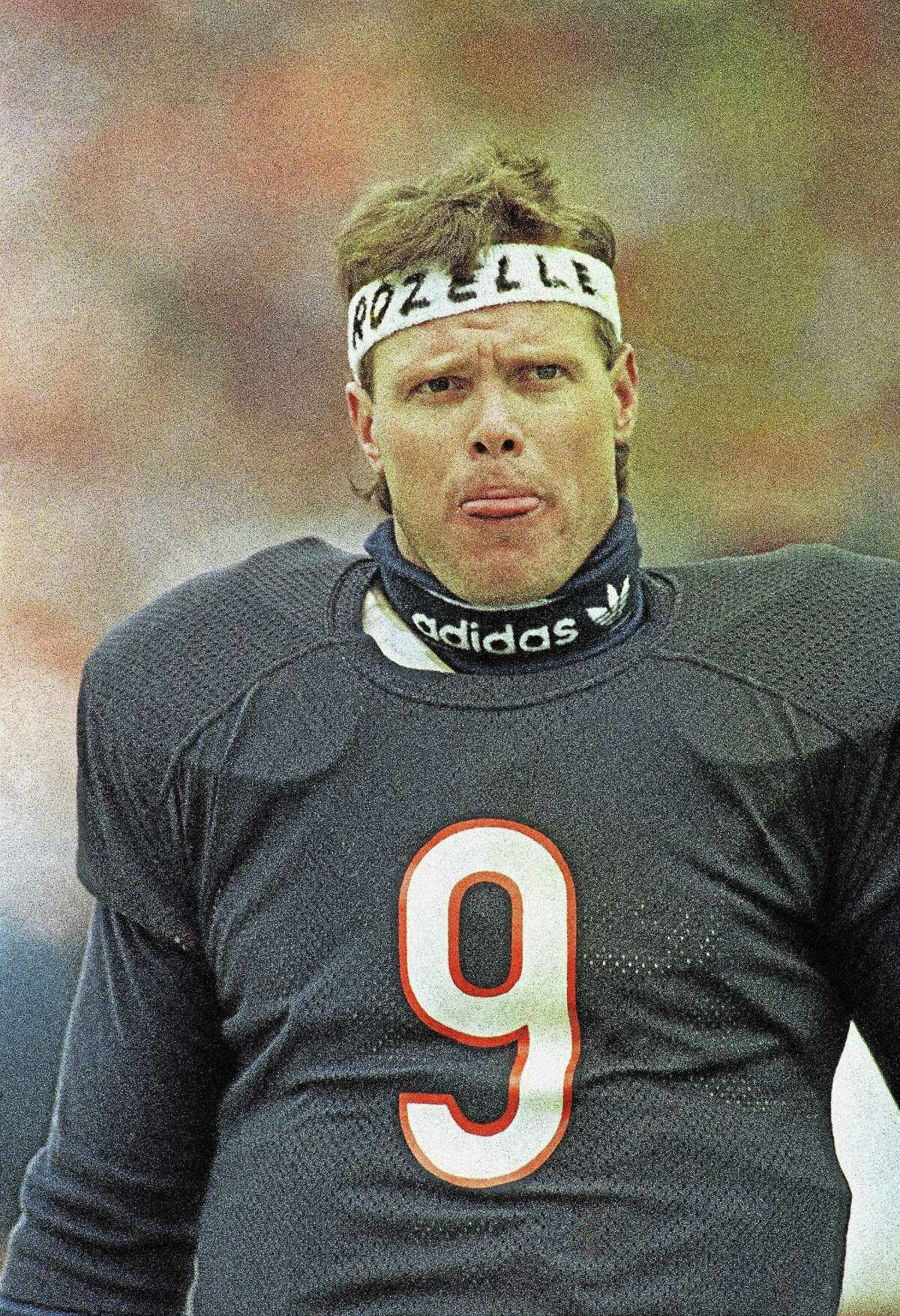 Jim McMahon, Bears quarterback sports a headband along the sidelines bearing the name Rozzelle in Chicago on Jan. 12, 1986. Football commissioner Pete Rozzelle had commented about McMahon’s headband worn during last weeks game.