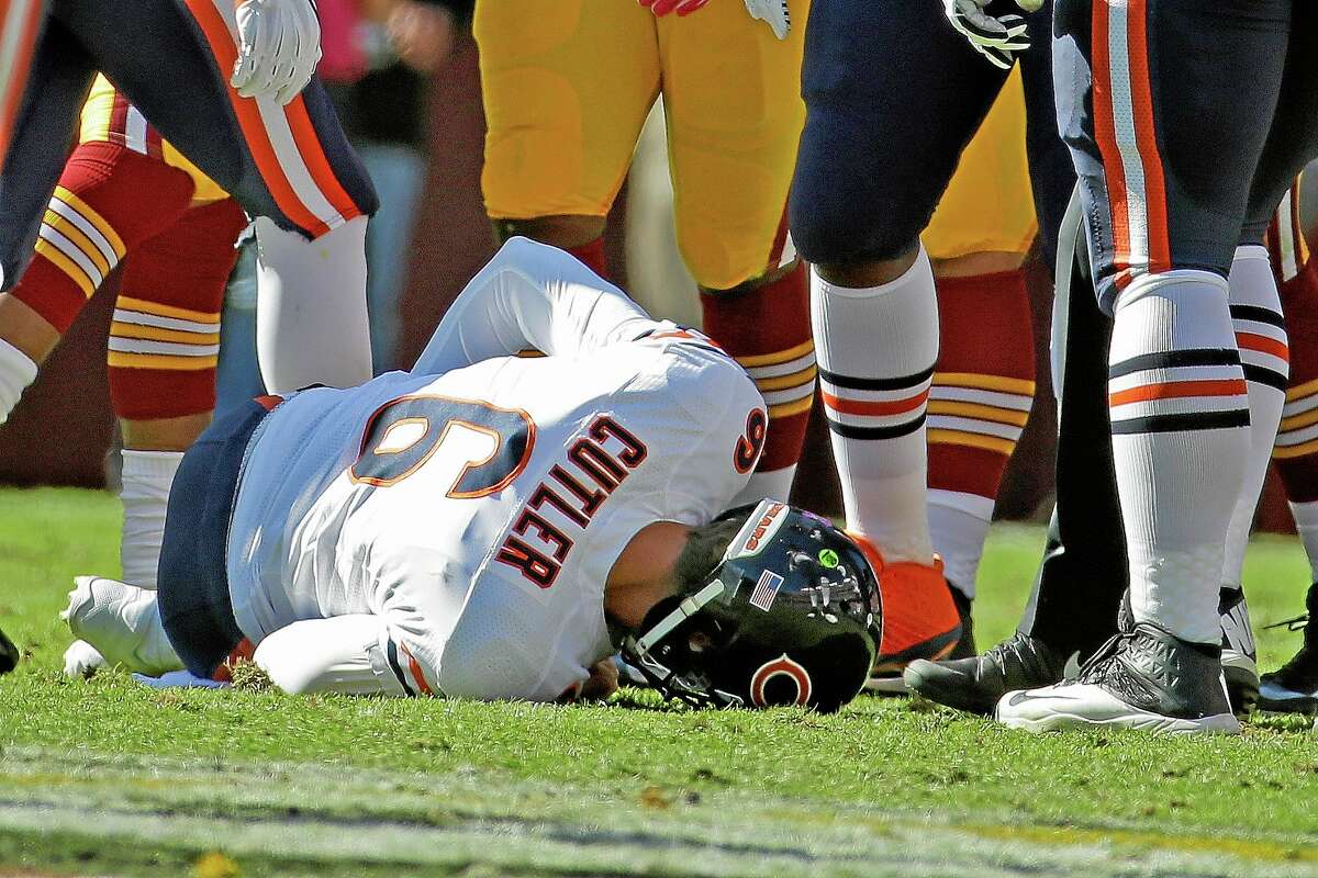 Chicago Bears quarterback Jay Cutler lies on the field after being injured during Sunday’s game against the Washington Redskins in Landover, Md.