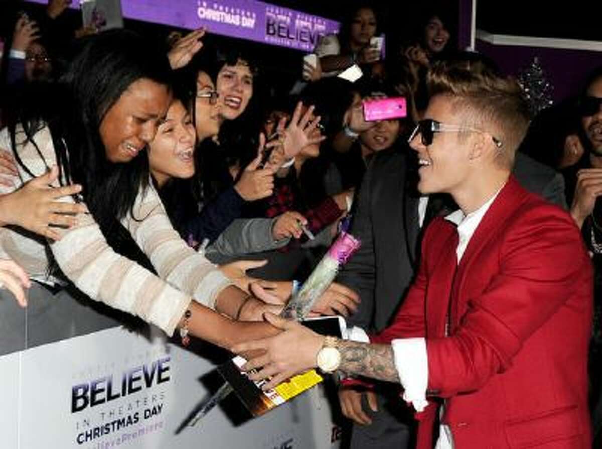 Singer Justin Bieber arrives at the premiere of Open Road Films' "Justin Bieber's Believe" at the Regal Cinemas L.A. Live on December 18, 2013 in Los Angeles, California.