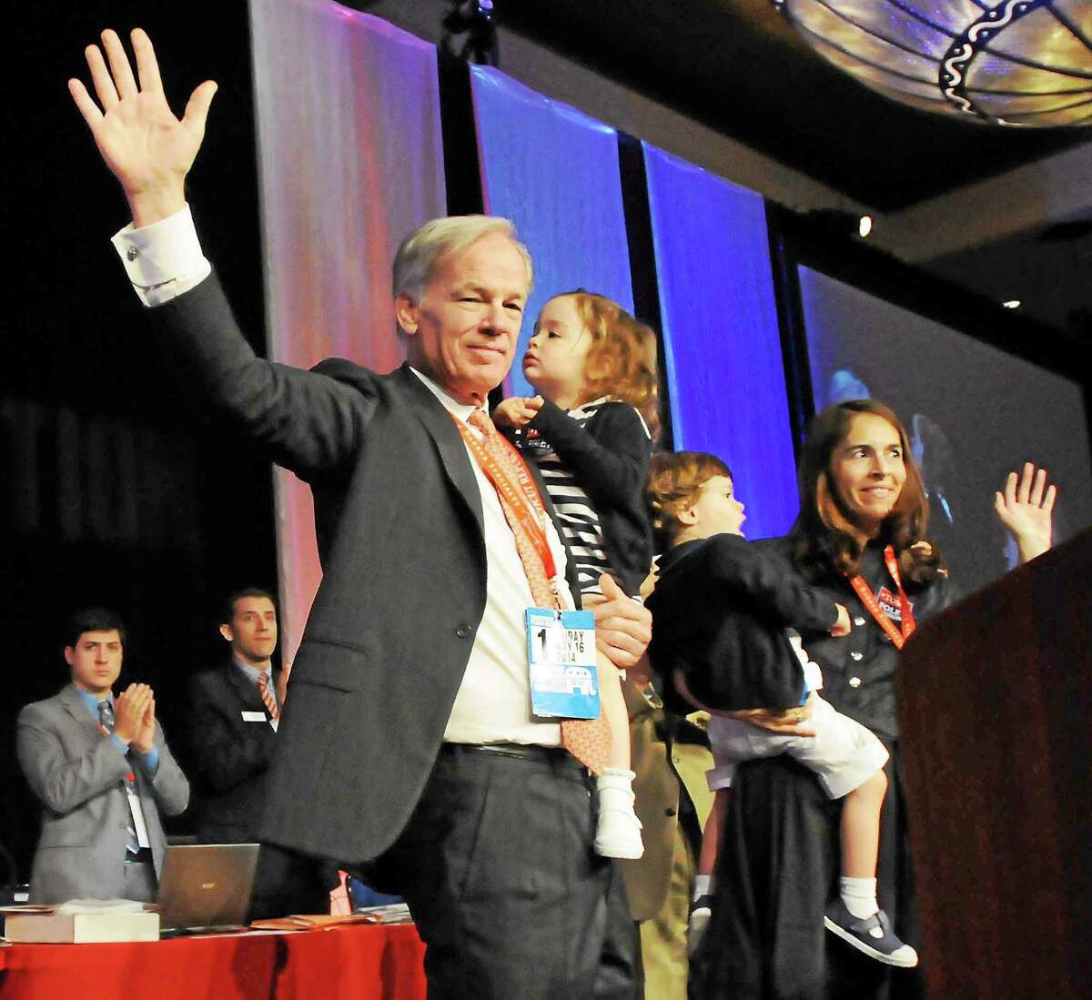 Tom Foley gets the Republican nomination for governor, as he waves holding his daughter Grace during the 2014 Connecticut Republican State Convention at the Mohegan Sun Convention Center in Uncasville Friday. On the right, his wife Leslie holds their son Reed.