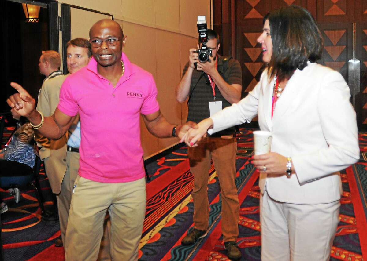 Penny Bacchiochi with her husband Emil Igwenagu after she was nominated for lieutenant governor during the 2014 Connecticut Republican State Convention at the Mohegan Sun Convention Center in Uncasville Friday.