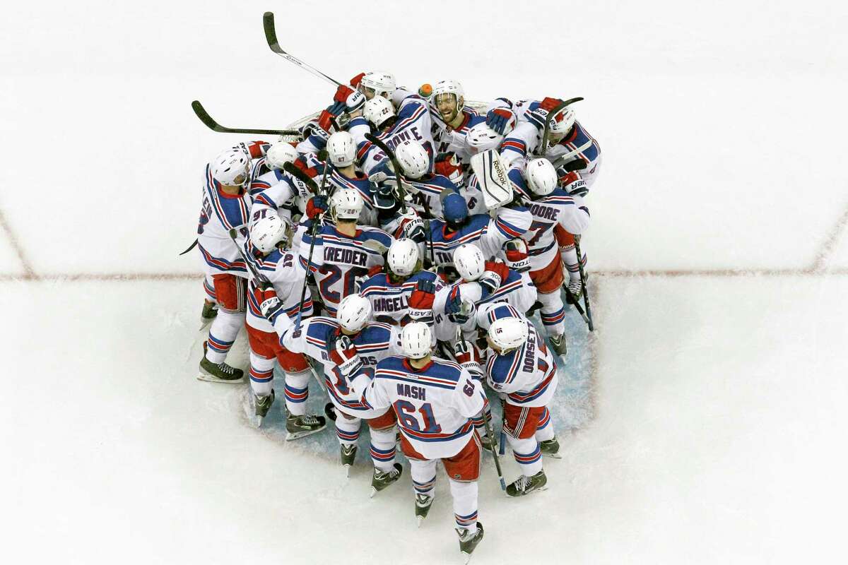 The New York Rangers congratulate goalie Henrik Lundqvist after Game 7 of their second-round playoff series win against the Penguins in Pittsburgh on Tuesday.