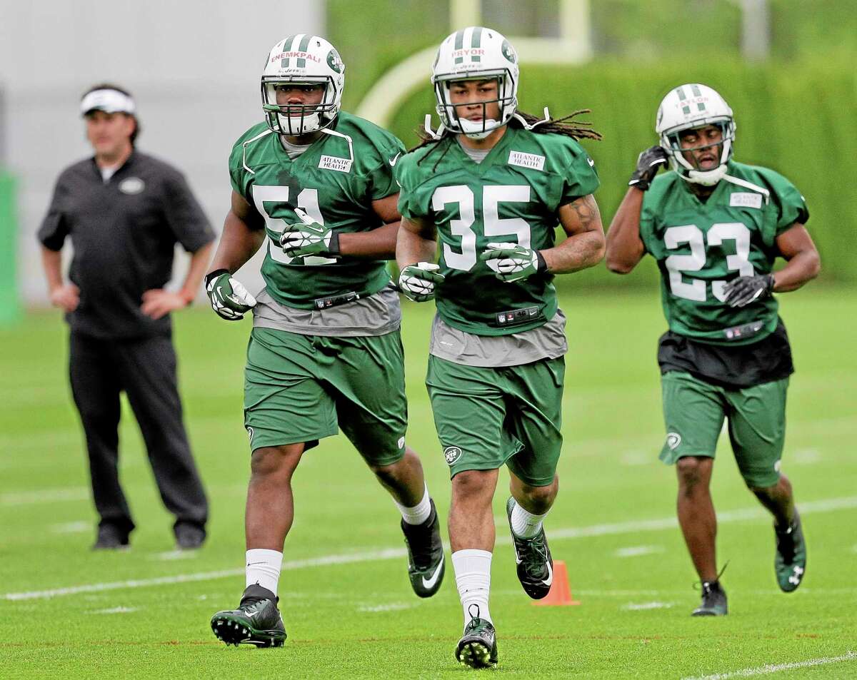 New York Jets safety Calvin Pryor (35) jogs to another drill with Ikemefuna Enemkpali (51) and Nick Taylor (23) during rookie camp on Friday in Florham Park, New Jersey.