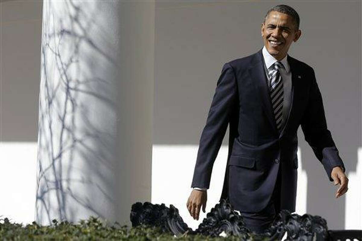 President Barack Obama looks towards reporters shouting questions as he walks down the West Wing Colonnade of the White House in Washington, Tuesday, Feb. 12, 2013, ahead of tonight's State of the Union speech on Capitol Hill. (AP Photo/Charles Dharapak)