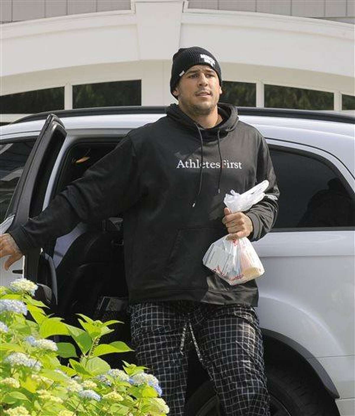 Aaron Hernandez returns to his home at Friday, June 21, 2013 in North Attleboro, Mass. At least one company yanked an endorsement deal from New England Patriots tight end Aaron Hernandez on Friday as puzzled family members of a friend found slain a mile from Hernandez's home sought answers about how he died. (AP Photo/The Boston Herald, Ted Fitzgerald) BOSTON GLOBE OUT; METRO BOSTON OUT; MAGS OUT; ONLINE OUT; MANDATORY CREDIT