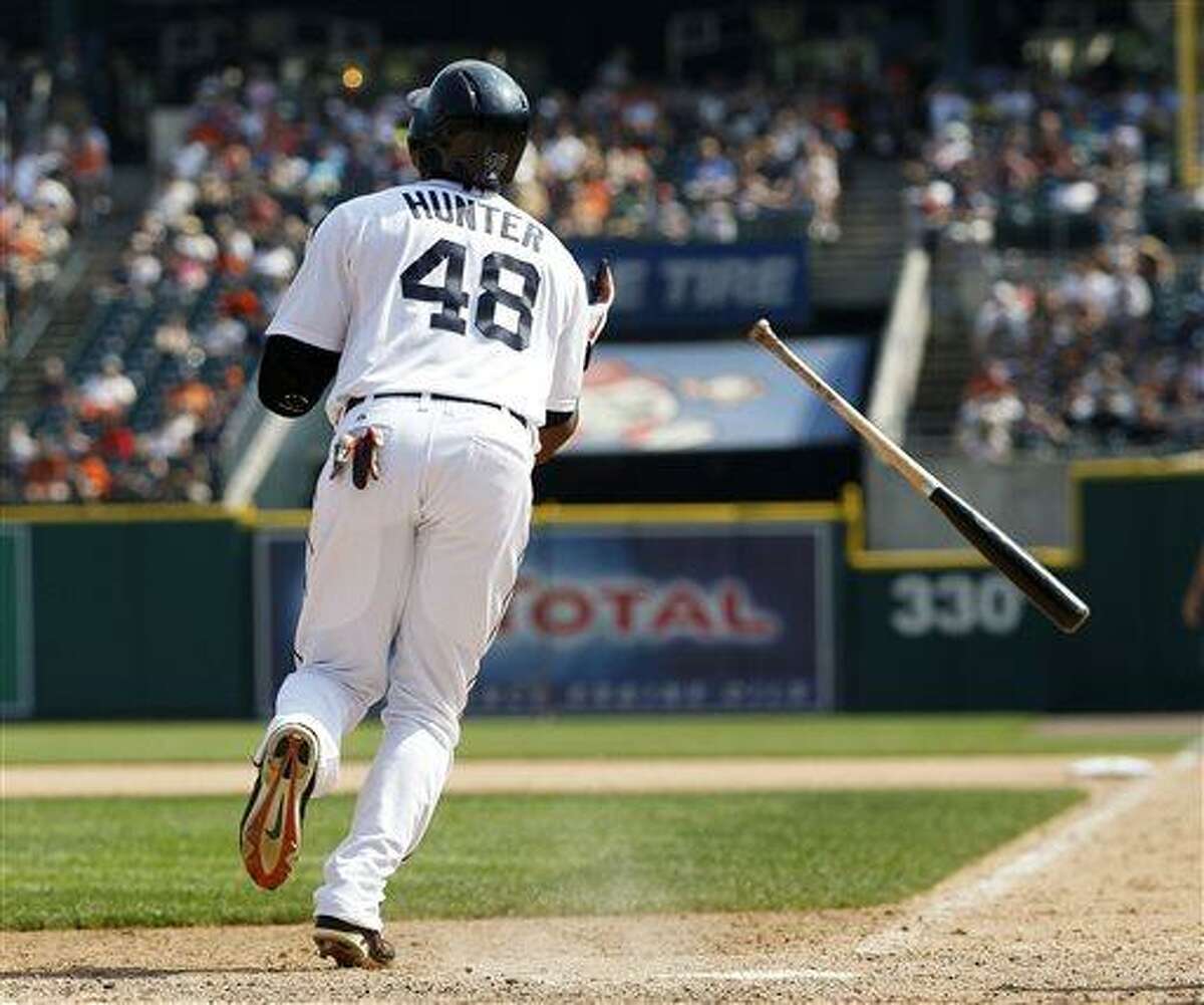 Detroit Tigers' Torii Hunter watches his sacrifice fly ball that scored Avisail Garcia to take a 5-4 lead over the Boston Red Sox in the eighth inning of a baseball game on Sunday, June 23, 2013, in Detroit. (AP Photo/Duane Burleson)