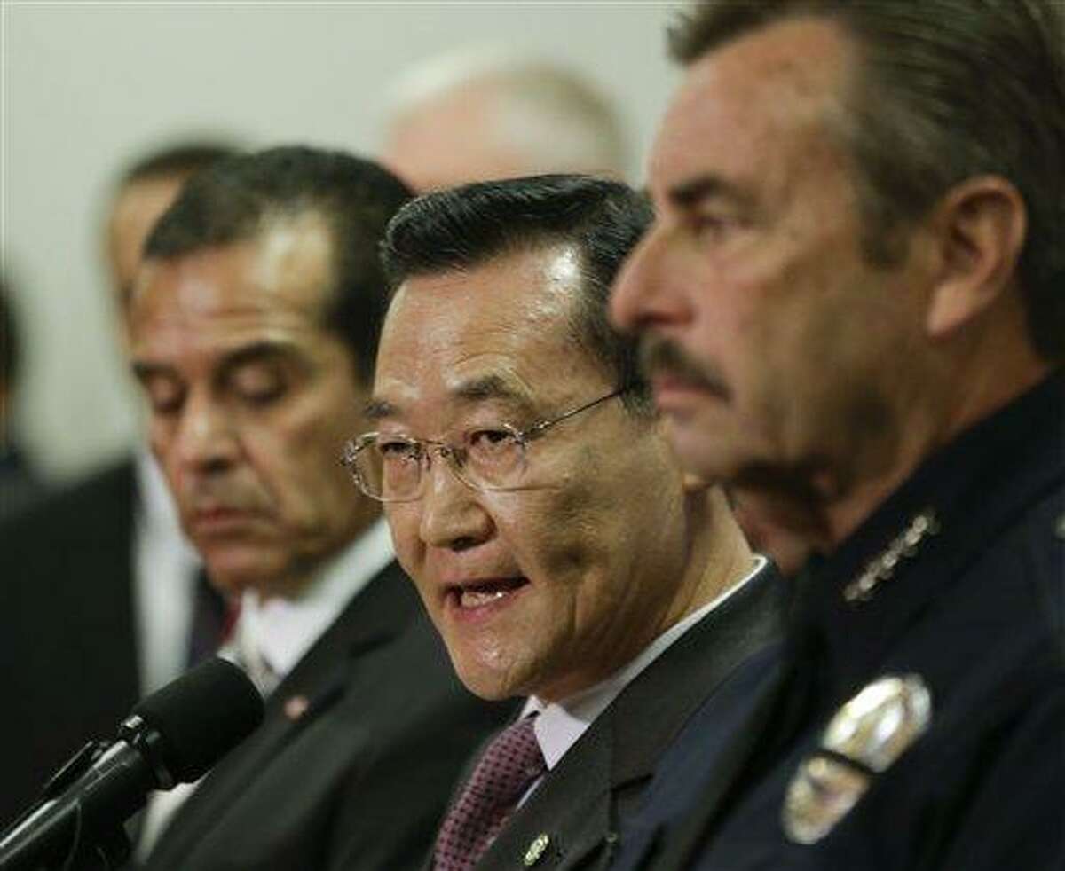 Irvine, Calif., Mayor Steven Choi, center, talks about the $1,000,000 reward for accused killer and fired Los Angeles police officer, Christopher Dorner as Los Angeles Mayor, Antonio Villaraigosa, left, and Los Angeles Police Chief Charlie Beck look on during a new conference at the Los Angeles police department in Los Angeles, Sunday, Feb. 10, 2013. (AP Photo/Chris Carlson)