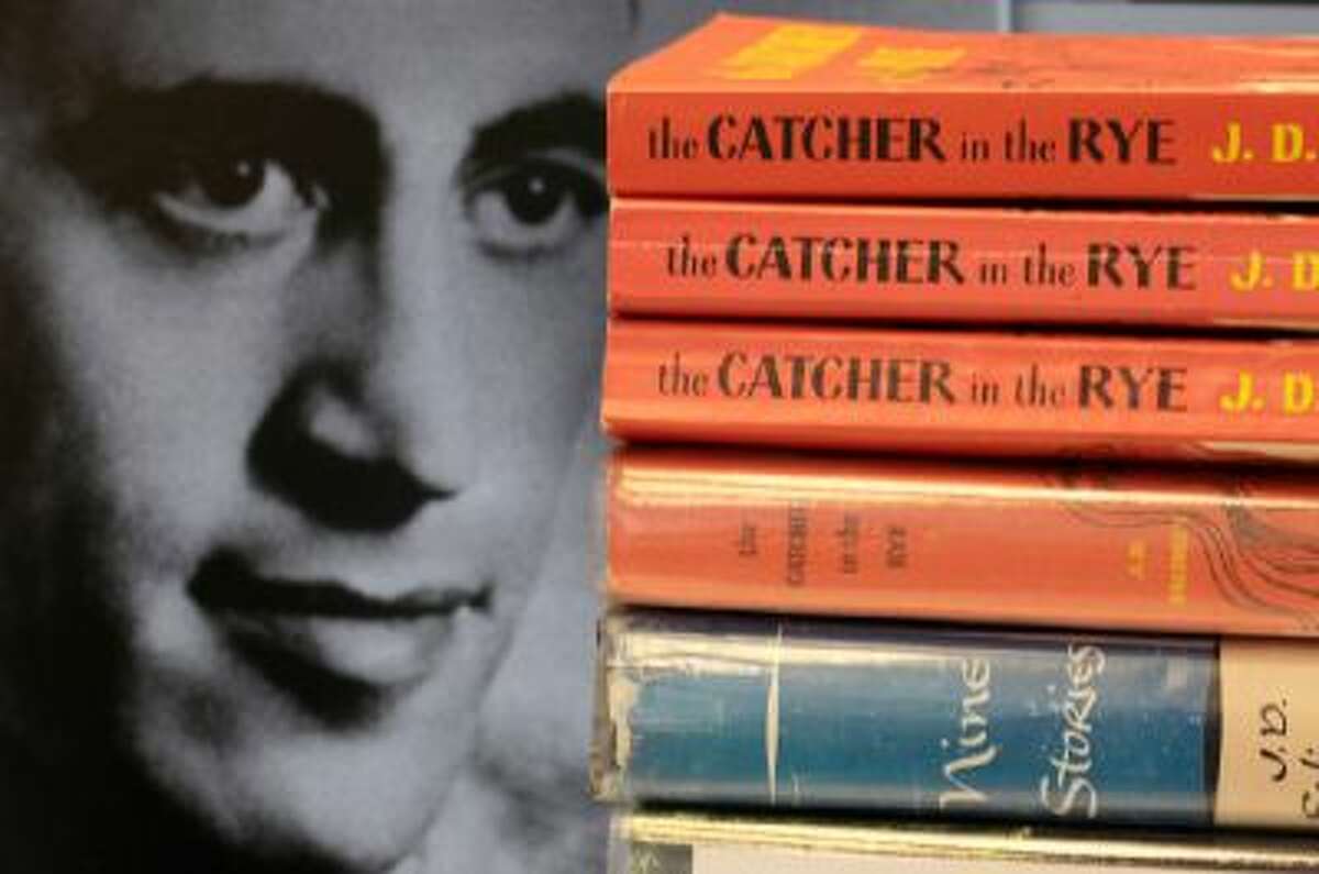 A photo of J.D. Salinger appears next to copies of his classic novel "The Catcher in the Rye" as well as his volume of short stories called "Nine Stories" at the Orange Public Library in Orange Village, Ohio.