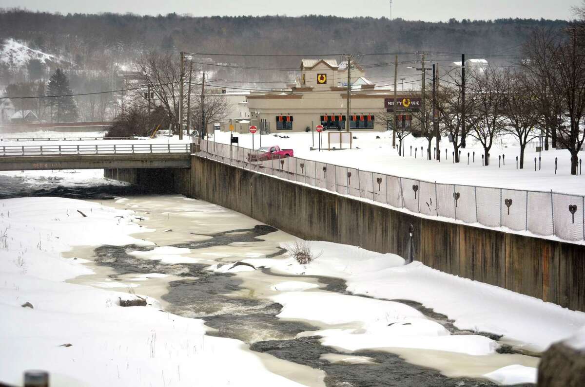 Snow and ice cover much of the Naugatuck River where it runs through the city of Torringon.John Berry/Register Citizen.