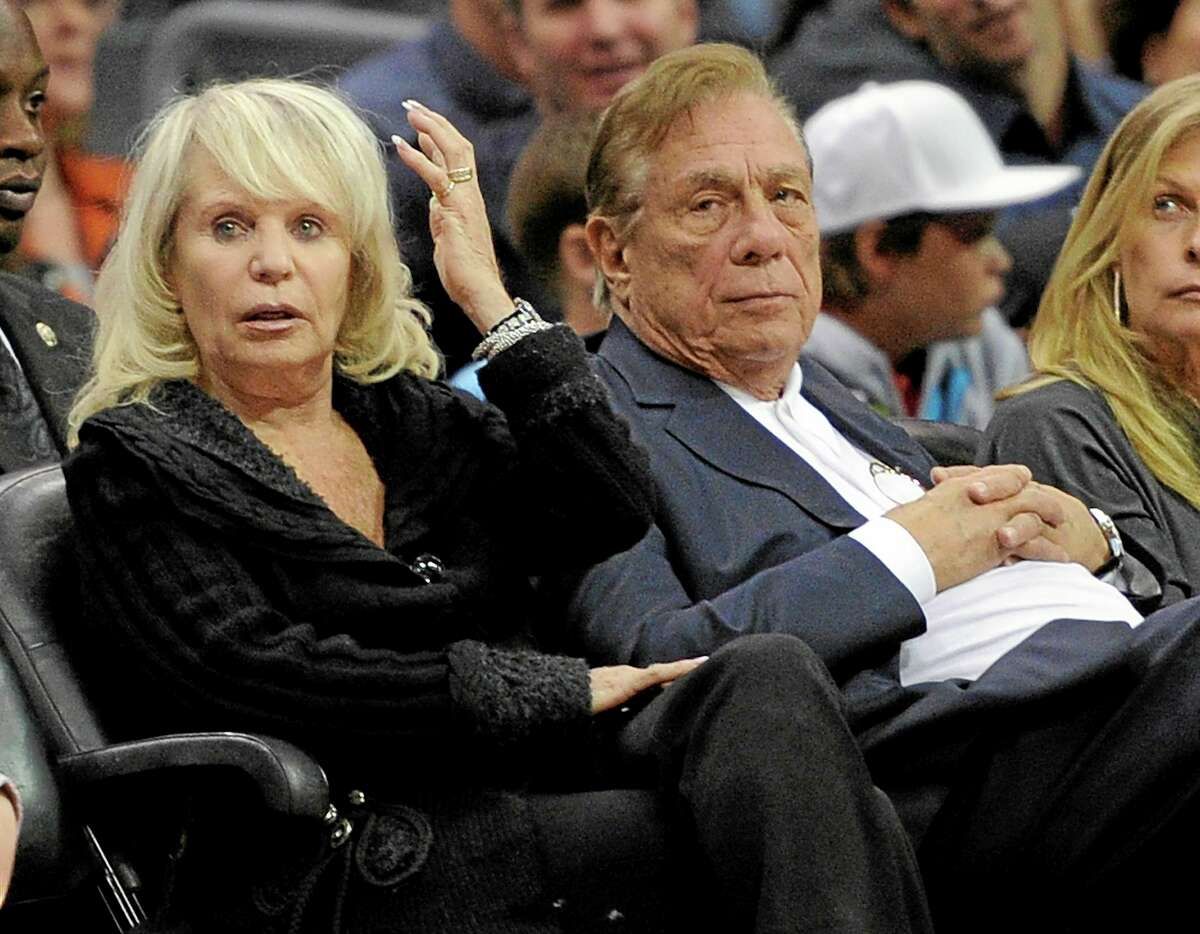 FILE - In this Nov. 12, 2010, file photo, Los Angeles Clippers owner Donald T. Sterling, right, sits with his wife Rochelle during the Clippers NBA basketball game against the Detroit Pistons in Los Angeles. An attorney representing the estranged wife of Clippers owner Donald Sterling said Thursday, May 8, 2014, that she will fight to retain her 50 percent ownership stake in the team. (AP Photo/Mark J. Terrill, File)