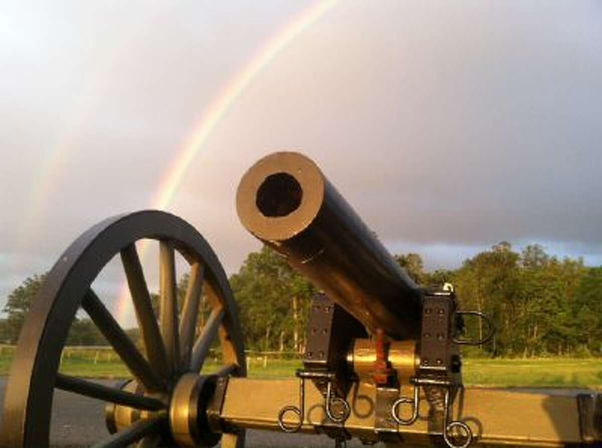 A rainbow provides a backdrop to a Civil War canon on the Gettysburg battlefield during the 150th anniversary of the battle, July 1-3, 2013.