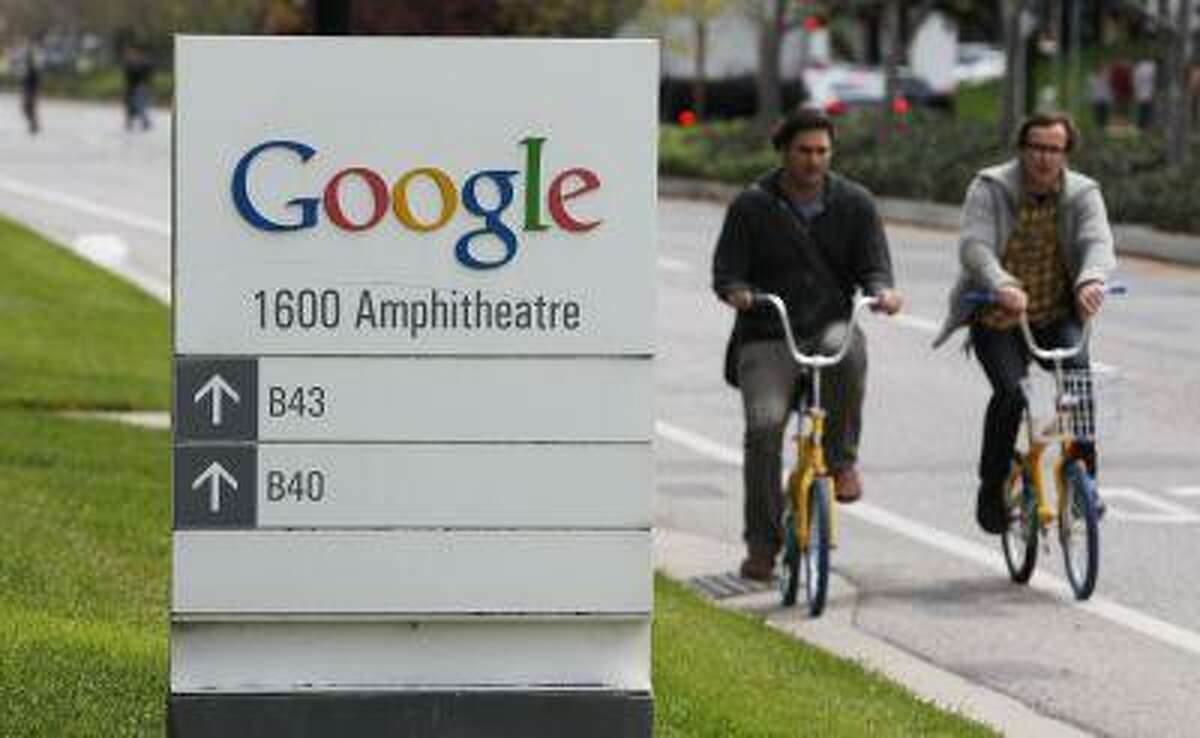 FILE - In this April 12, 2012 file photo, Google workers ride bikes outside of Google headquarters in Mountain View, Calif. Google on Tuesday, June 18, 2013, sharply challenged the federal government's gag order on its Internet surveillance program, citing what it described as a First Amendment right to divulge how many requests it receives from the government for data about its customers in the name of national security. (AP Photo/Paul Sakuma, File)