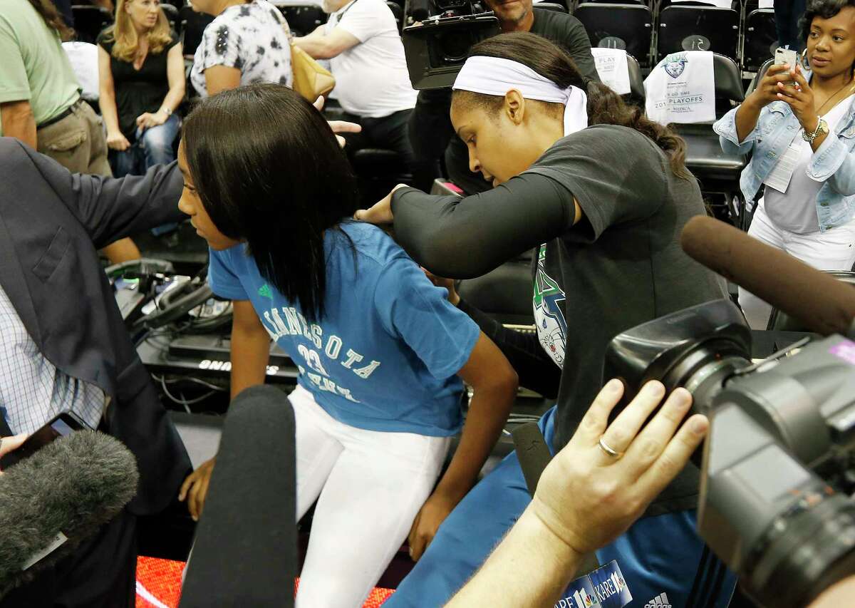 Minnesota Lynx forward Maya Moore signs Little League World Series pitcher Mo’ne Davis’ shirt prior to Game 2 of the WNBA Western Conference finals on Sunday in Minneapolis.