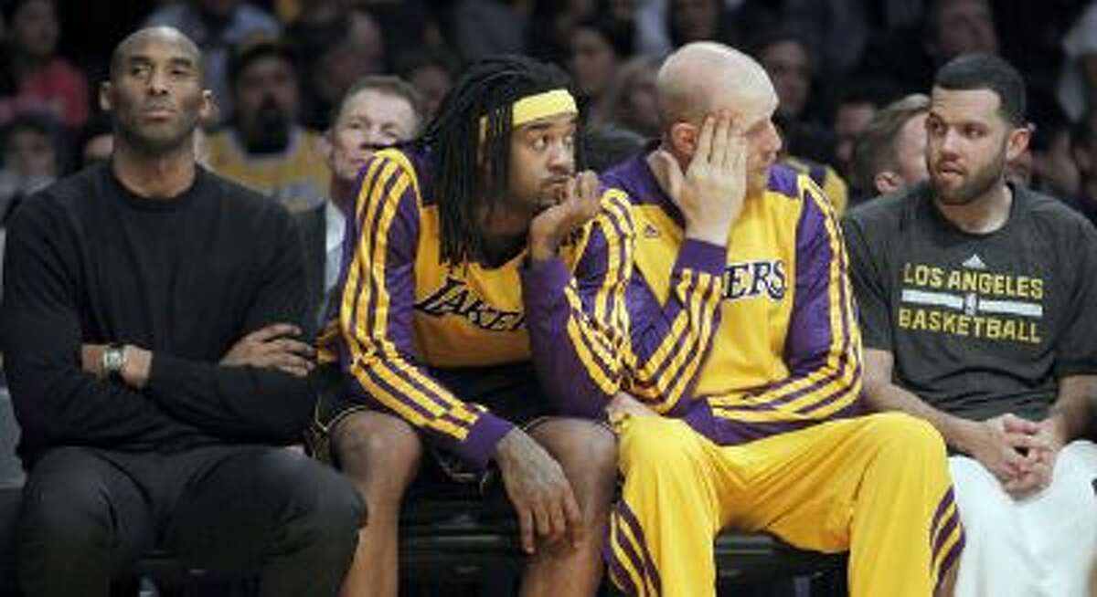 Kobe Bryant watches from the bench of a 94-79 loss to the Milwaukee Bucks.