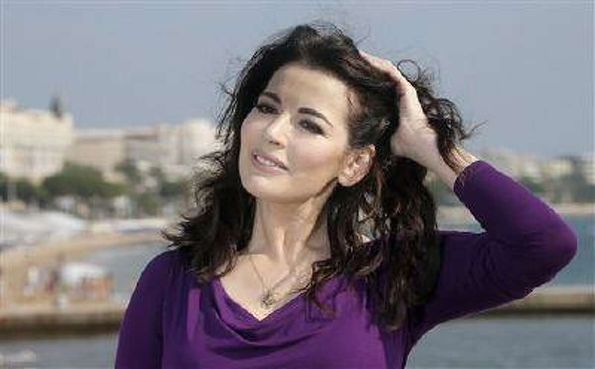 FILE - In this Tuesday, Oct. 9, 2012 file photo, English food writer, journalist and broadcaster, Nigella Lawson poses during the 28th MIPCOM (International Film and Programme Market for Tv, Video,Cable and Satellite) in Cannes, southeastern France. British police say they are investigating after a newspaper published photos of Nigella Lawson's husband Charles Saatchi with his hands around the celebrity chef's throat. The Sunday People newspaper ran pictures of what it said was the couple's violent argument at a London restaurant on June 9, 2013. (AP Photo/Lionel Cironneau, File)
