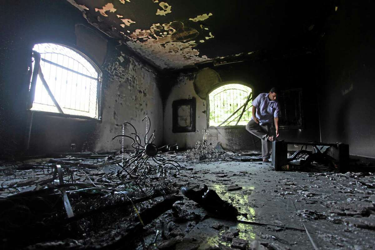AP file photo This Sept 13, 2012, photo shows a Libyan man investigating the inside of the U.S. Consulate in Benghazi, Libya, after an attack that killed four Americans, including Ambassador Chris Stevens.
