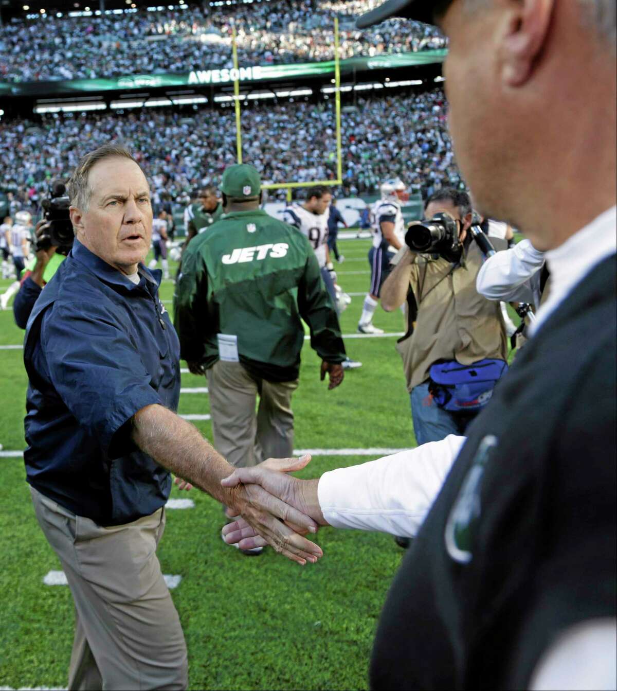 New England Patriots head coach Bill Belichick shakes hands with New York Jets head coach Rex Ryan after Sunday’s game in East Rutherford, N.J. The Jets won the game 30-27.