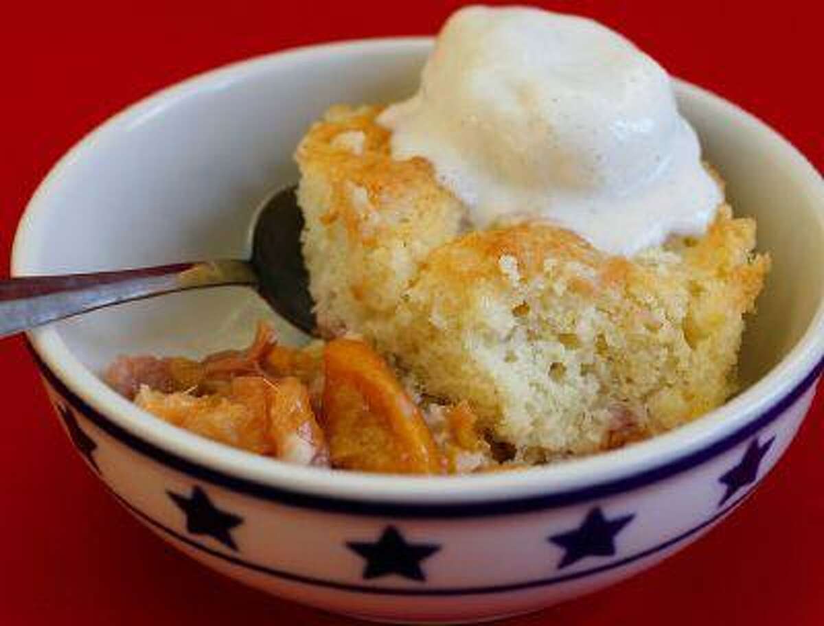 Peach cobbler with vanilla ice cream. A cobbler is a dessert consisting of sugared fruit topped with a sweetened biscuit topping. Illustrates HOWTO-COBBLER (category d), by L.V. Anderson (c) 2013, Slate. Moved Monday, June 17, 2013. (MUST CREDIT: Slate photo by Ellie Skrzat.)
