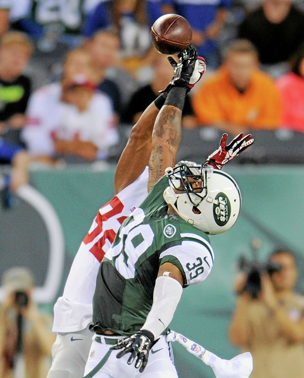New York Jets free safety Antonio Allen (39) breaks up a pass intended for New York Giants receiver Rueben Randle (82) in an Aug. 22 preseason game in East Rutherford, N.J.