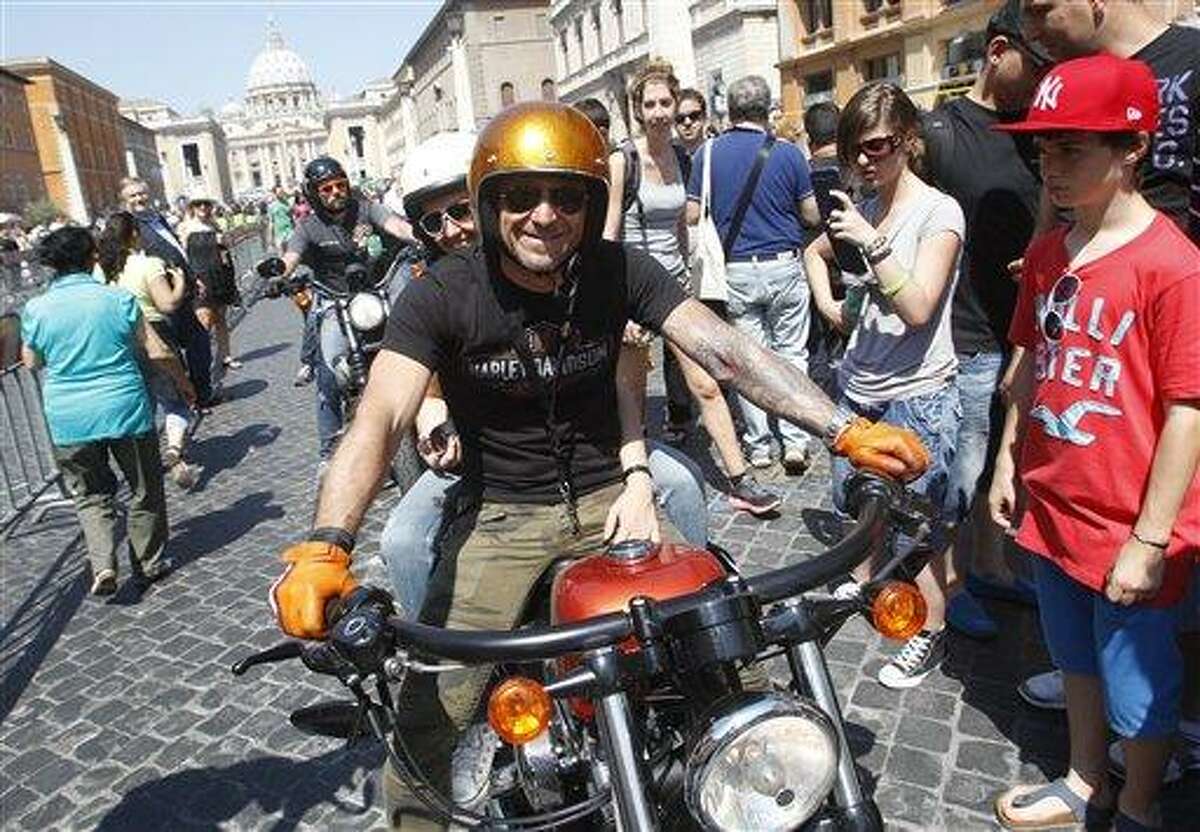 Harley-Davidson riders parade in Via della Conciliazione leading to St. Peter's Square during a Mass celebrated by Pope Francis, at the Vatican, Sunday, June 16, 2013. Pope Francis on Sunday blessed thousands of Harley Davidsons and their riders as the American motorcycle manufacturer celebrated its 110th anniversary with a loud parade and plenty of leather. (AP Photo/Riccardo De Luca)