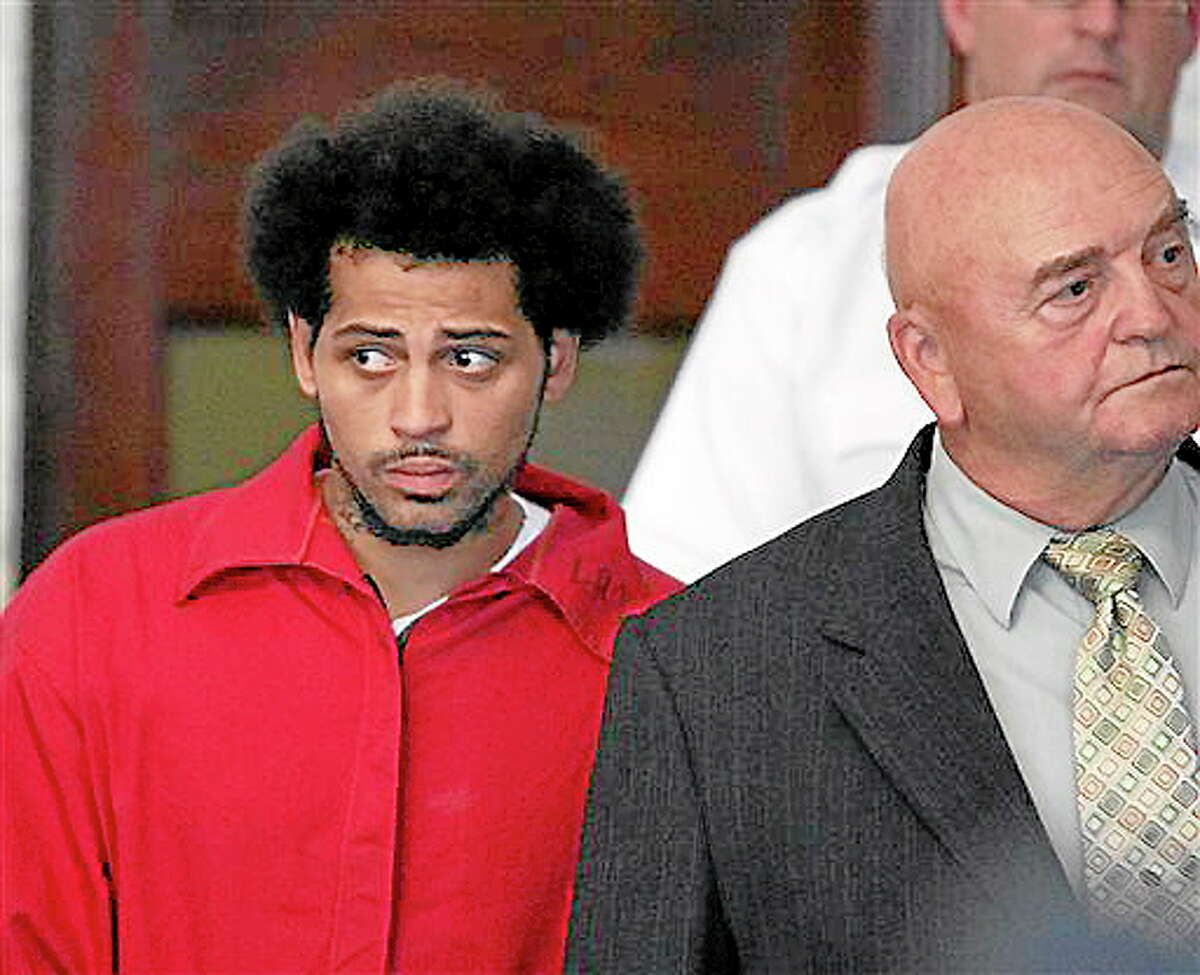 In this June 28 file photo, Carlos Ortiz, an associate of ex-New England Patriot Aaron Hernandez, enters the Attleboro District Court with attorney John Connors, right, for his arraignment on weapons charges in Attleboro, Mass. Ortiz was arraigned Friday on an accessory to murder charge related to the case against Hernandez. He pled not guilty.