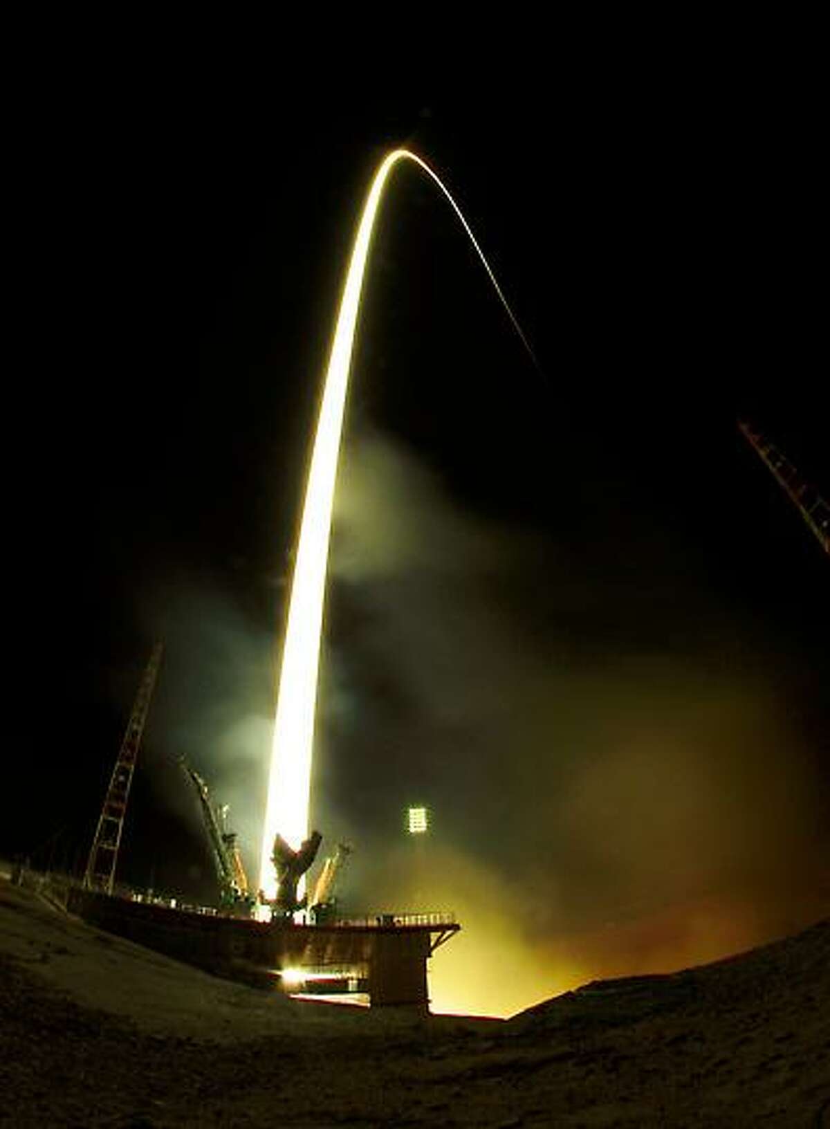 In this photo taken with a fisheye lens and with long time exposure the Soyuz-FG rocket booster with Soyuz TMA-08M space ship carrying a new crew to the International Space Station, ISS, blasts off at the Russian leased Baikonur cosmodrome, Kazakhstan, early Friday, March 29, 2013. The Russian rocket carries Russian Cosmonauts Alexander Misurkin and Pavel Vinogradov and U.S. astronaut Christopher Cassidy. (AP Photo/Dmitry Lovetsky)