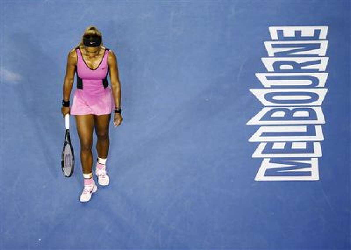 Serena Williams of the United States walk on the court between points as she plays Ashleigh Barty of Australia during the first round match at the Australian Open tennis championship in Melbourne, Australia, Monday, Jan. 13, 2014.