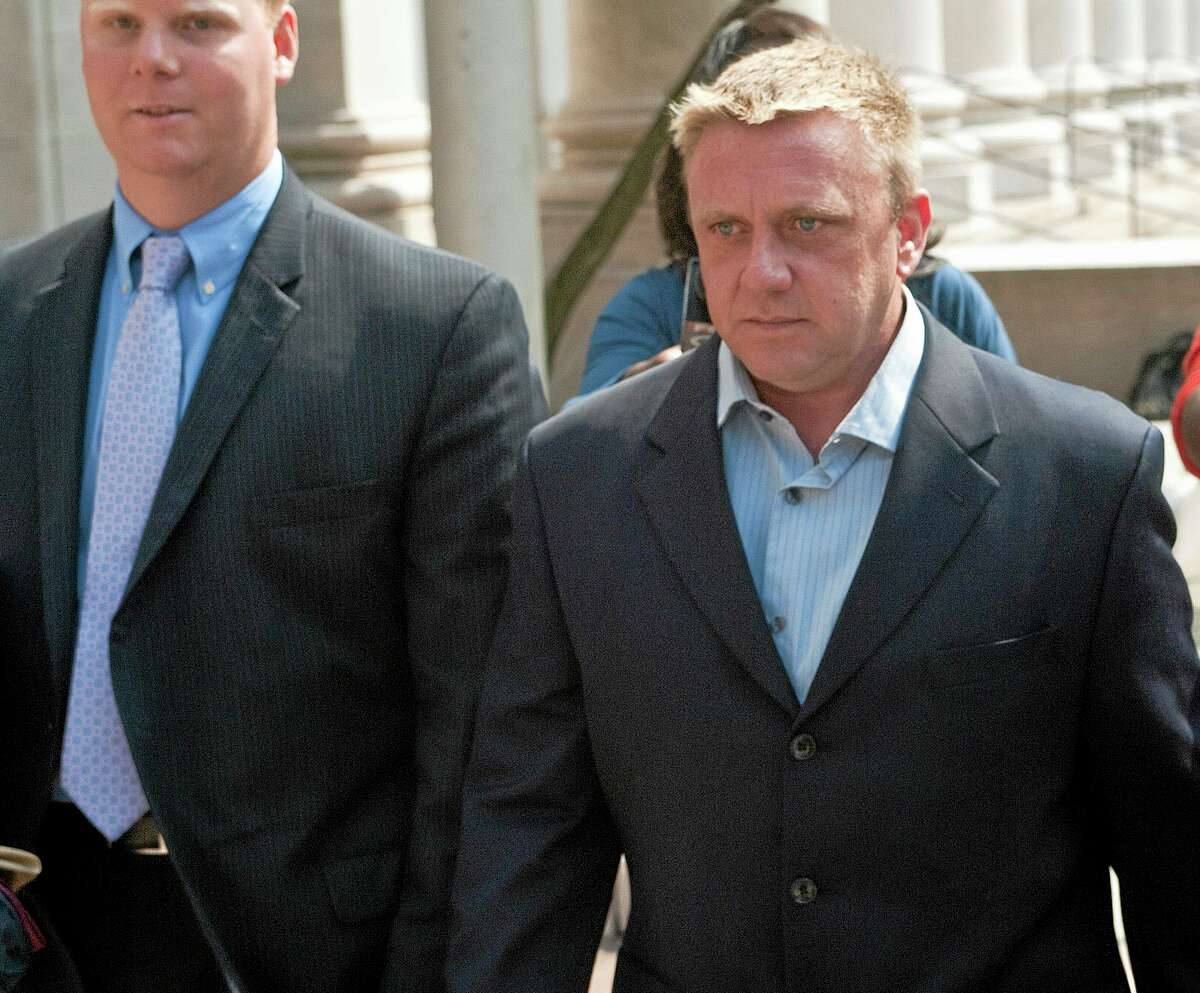 In this July 26, 2012, photo, Paul Rogers, right, leaves federal court in New Haven after a hearing about his role in funneling illegal campaign donations to former House Speaker Chris Donovan’s former campaign manager.