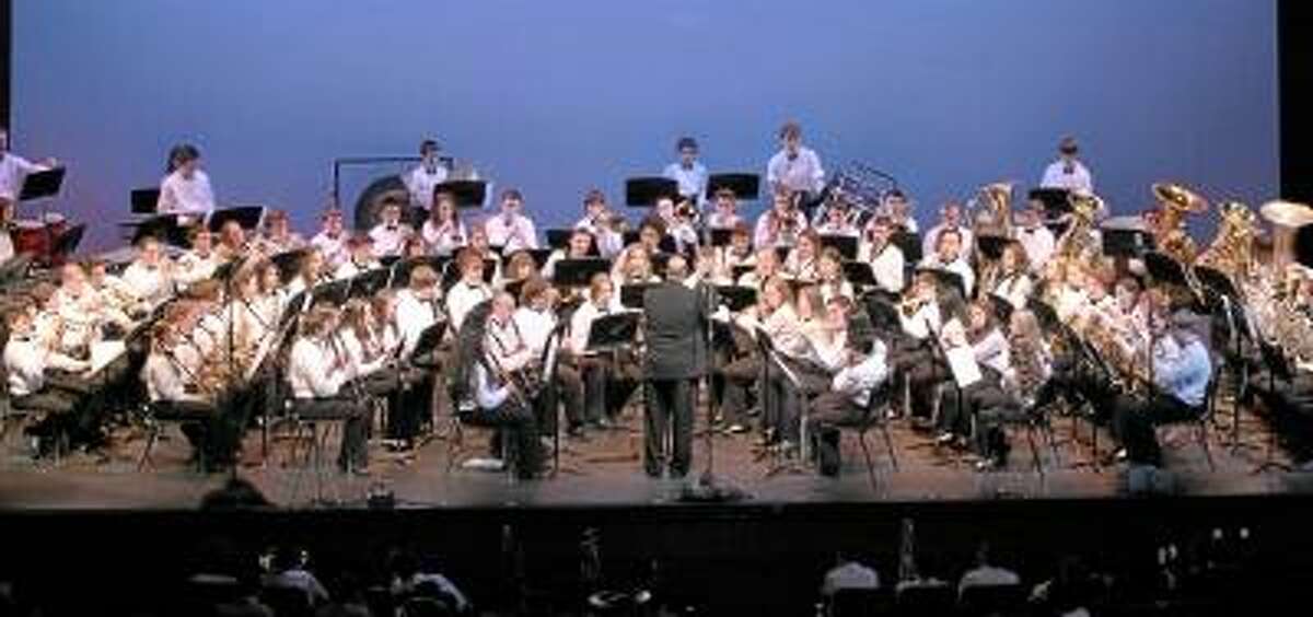 Photo by Marianne Killackey. Wayne Splettstoeszer conducts the Torrington High School Concert Band as they perform in the Tri Town Band Festival, a collaborative effort of Torrington, Northwestern Regional 7, and Canton High Schools. The concert was held at the Warner Theatre on Tuesday night.