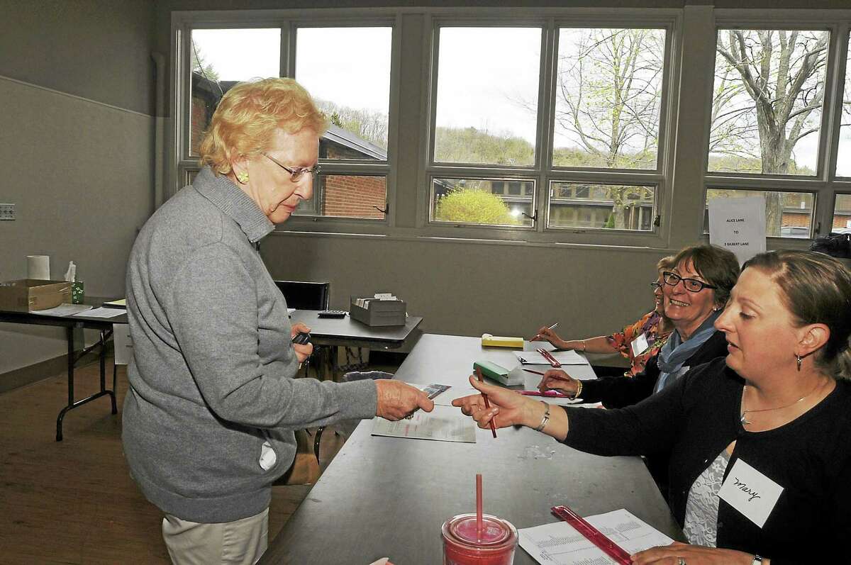 Gloria Benedict checks in to vote in Burlington Tuesday as the town residents vote on the proposed budget for Region 10.