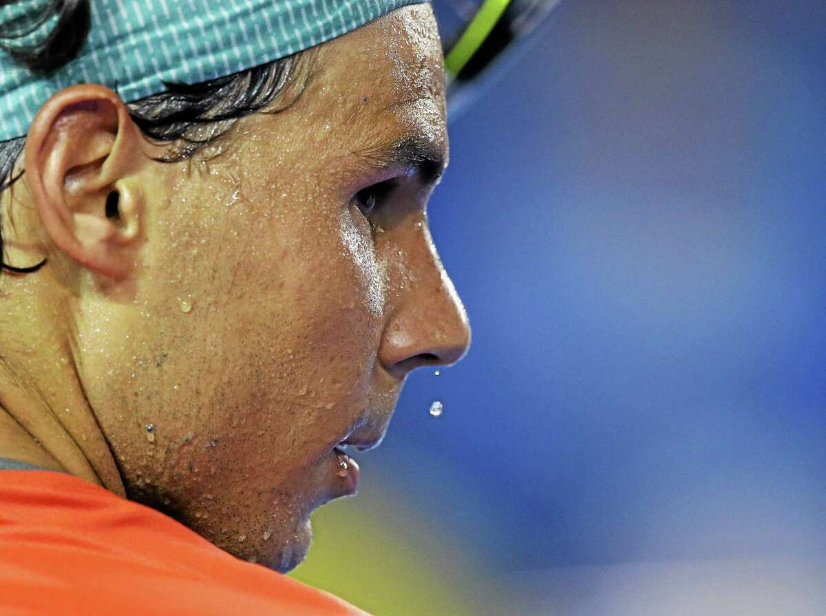 Sweat drips from the face of Rafael Nadal during a break in his first-round match against Bernard Tomic at the Australian Open in Melbourne, Australia, on Tuesday.