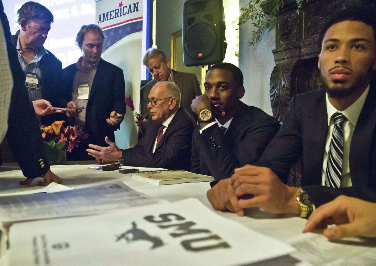 SMU head coach Larry Brown, seated third from right, and Mustangs Ryan Manuel, second from right, and Cannen Cunningham, far right, answer questions during the American Athletic Conference media day on Wednesday in New York.