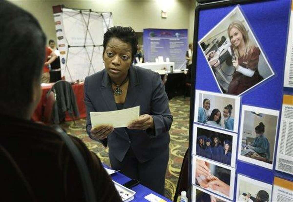 In this Feb. 28, 2013 photo Shawn Gordon, corporate presenter of the Dorsey Schools listens to a job applicant at the JobFairGiant.com employment fair in Dearborn, Mich. Fewer Americans sought unemployment aid last week, reducing the average number of weekly applications last month to a five-year low. The drop shows that fewer layoffs are strengthening the job market. The Labor Department said Thursday, March 14, 2013 that applications fell 10,000 to a seasonally adjusted 332,000. That cut the four-week average to 346,750, the lowest since March 2008, just several months after the Great Recession began. (AP Photo/Carlos Osorio)