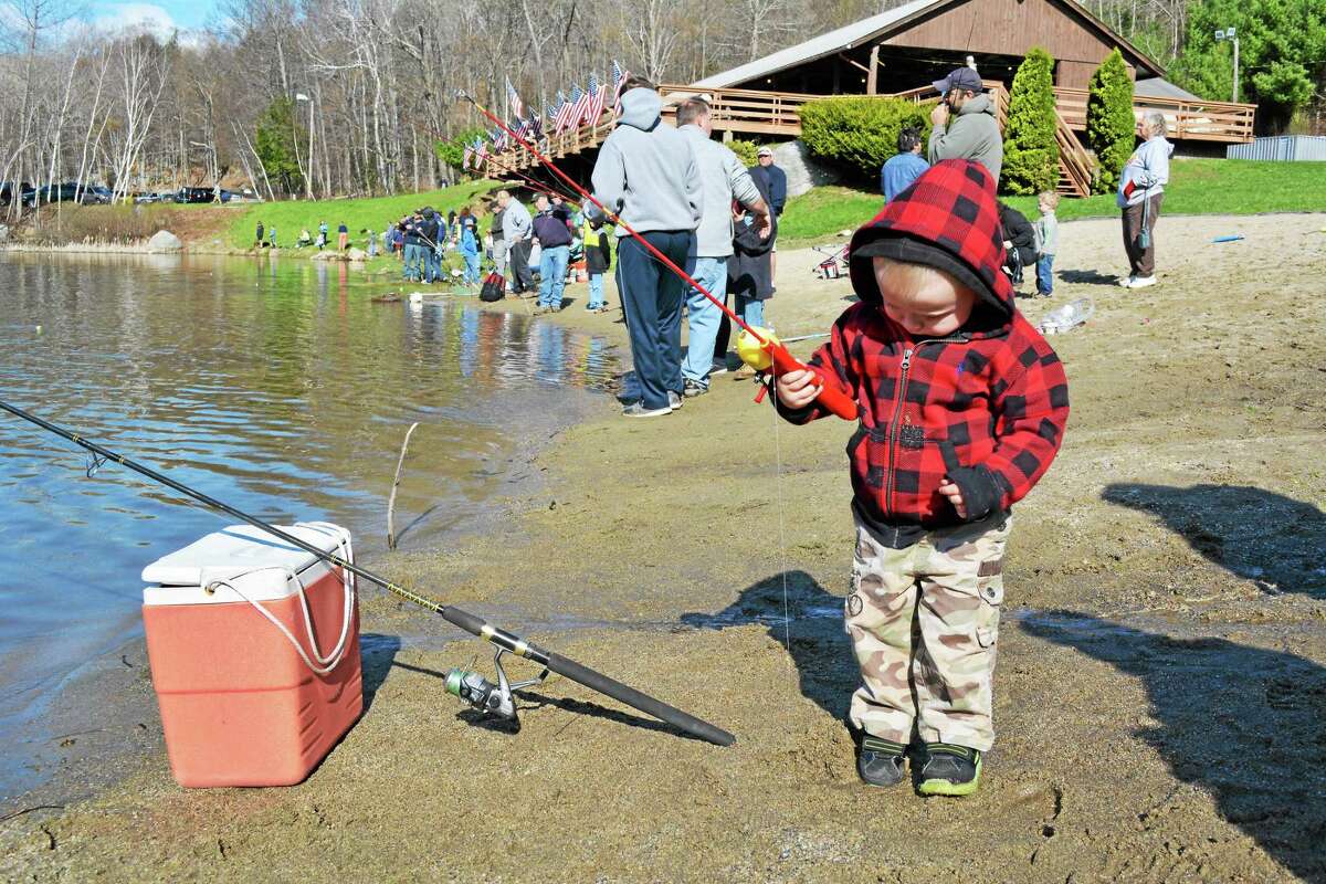 Wyatt Lentini, who will be two in June, took part (with a lot of assistance) in the Elks Lodge's 44th annual children's fishing derby Sunday. John Berry - The Register Citizen