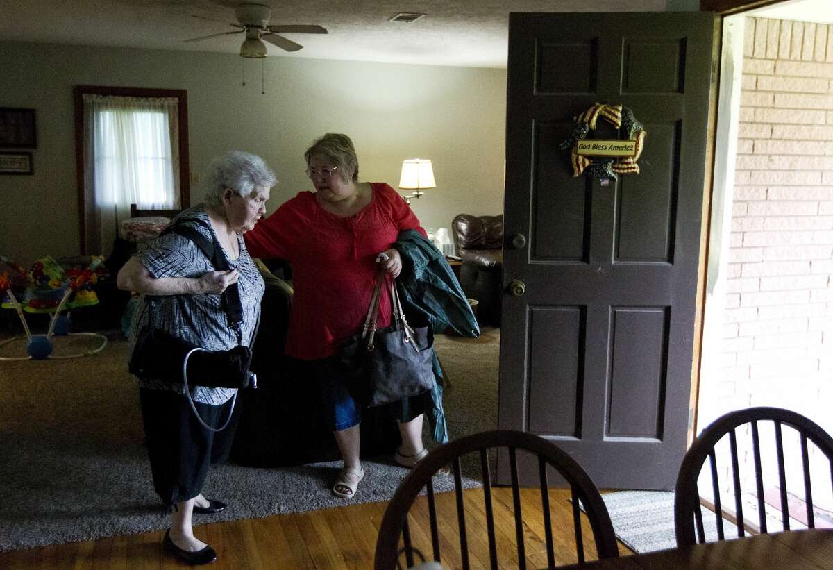 Bobbie Jones, center, helps her mother Regina Smith as they evacuate their home on East Hammond Drive to escape flooding from Tropical Storm Harvey, Sunday, Aug. 27, 2017, in New Caney.