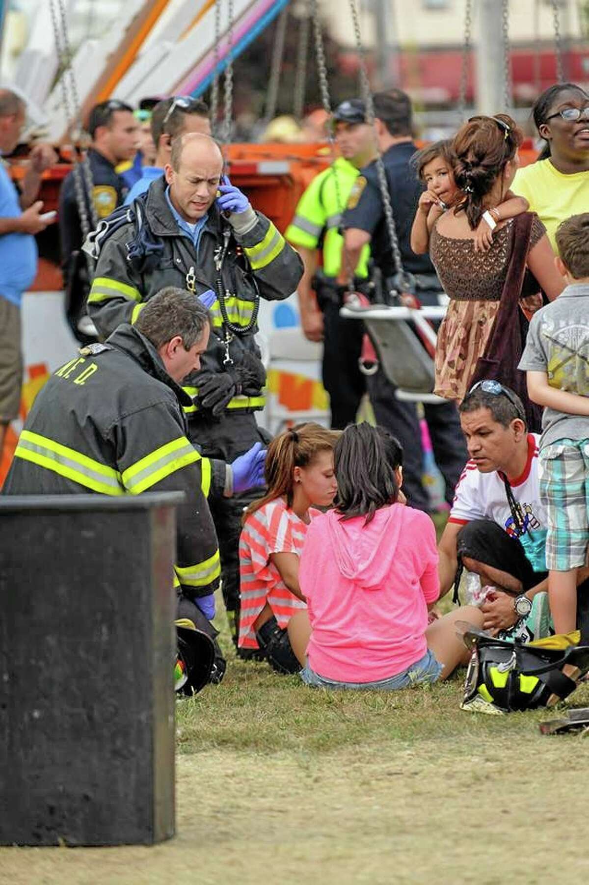 Thirteen children were injured when a festival attraction that swings riders into the air lost power at a community fair in Norwalk, Conn, on Sunday Sept. 8, 2013, but none of the injuries appeared to be life-threatening, authorities said. Most of the children suffered minor injuries and were treated at the Oyster Festival in Norwalk, police said. Norwalk Police Chief Thomas Kulhawik said there were initial reports of serious injuries but preliminary indications are that the injuries were not as severe as first feared. (AP Photo/The Hour Miguel Cruz) MANDATORY CREDIT