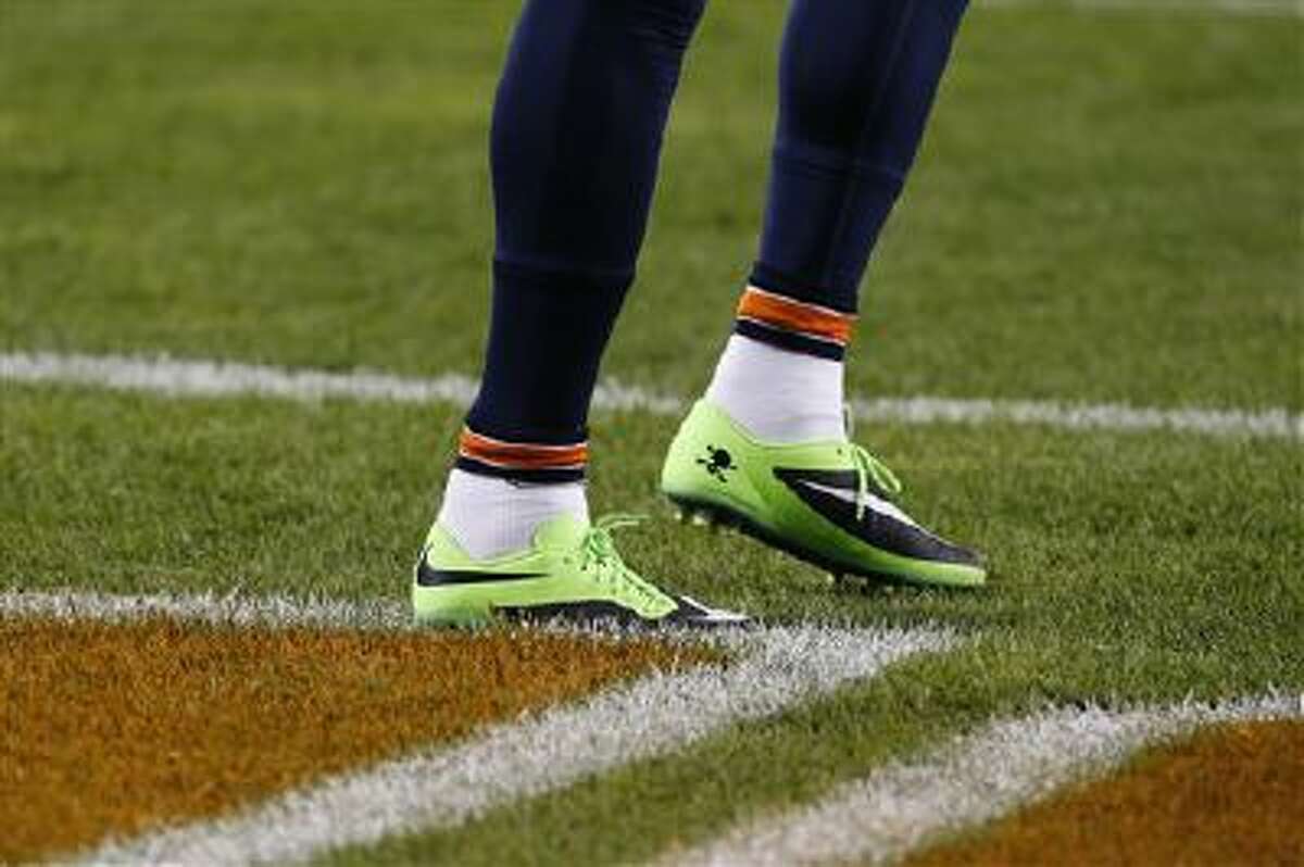 Chicago Bears wide receiver Brandon Marshall's shoes are seen as he warms up before a game against the New York Giants, Thursday, Oct. 10, 2013, in Chicago. Marshall plans to auction off the footwear and donate the proceeds to a charity supporting mental health awareness.